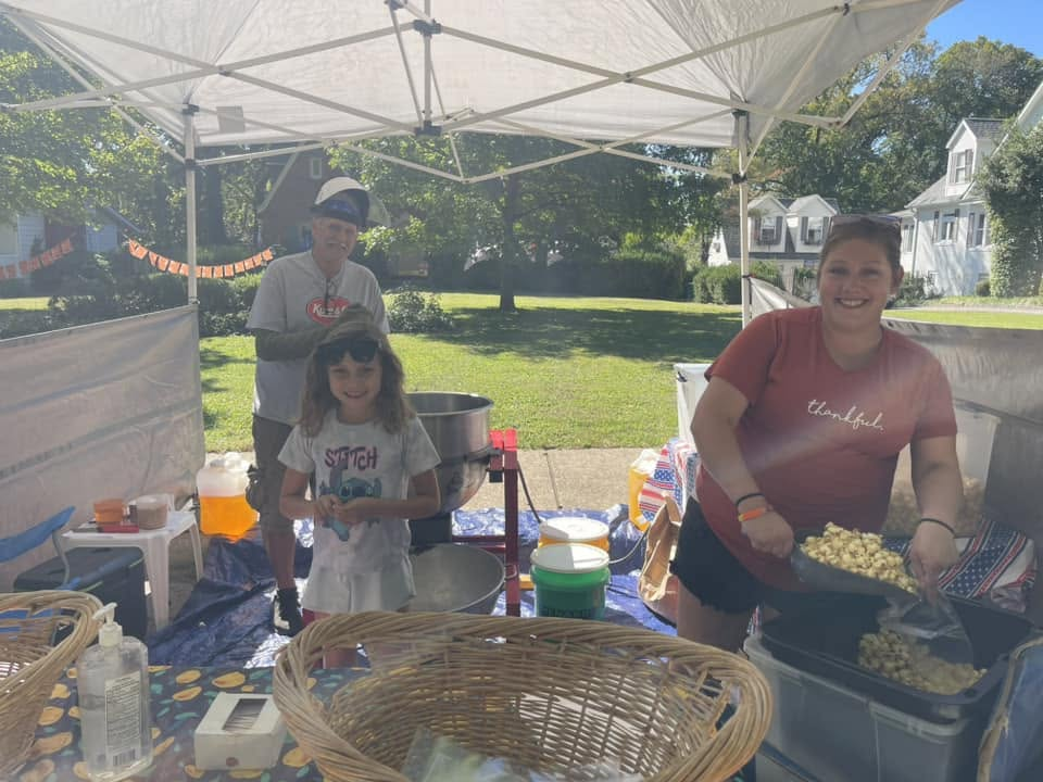 Neighbors making popcorn beneath a canopy
