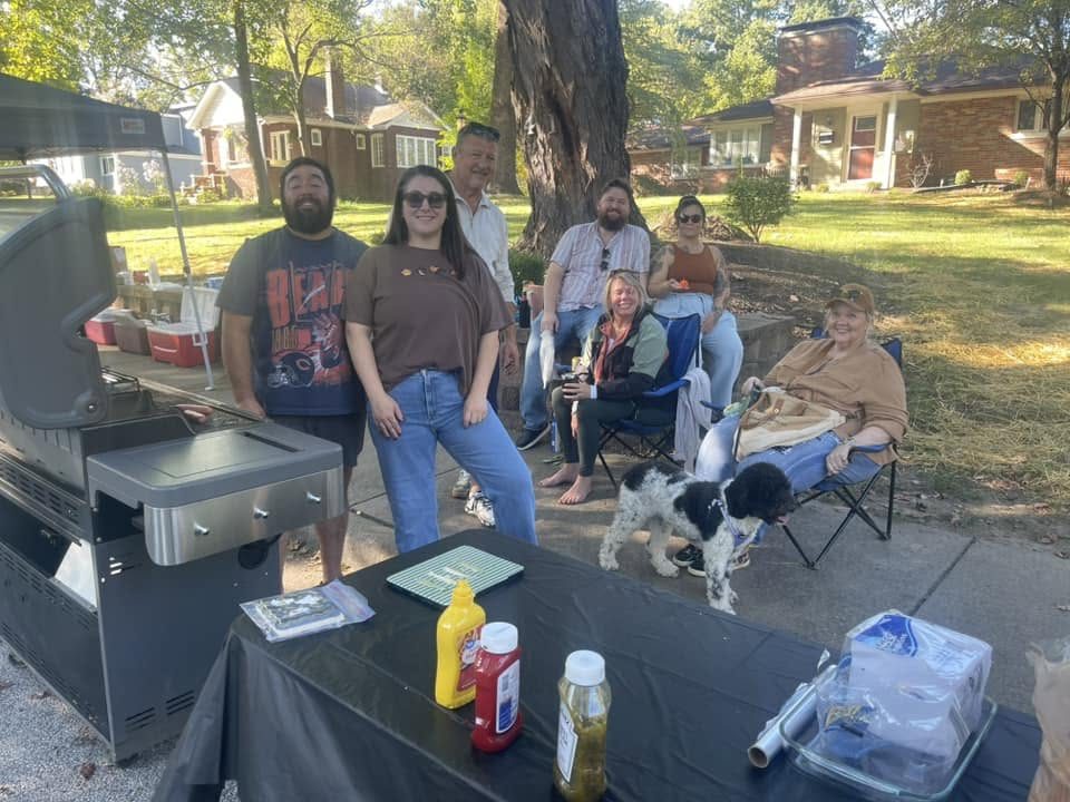 Neighbors gathered by a grill and table on the Boulevard